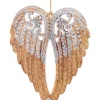 Ornement, ailes d'ange dorées et pailletées.