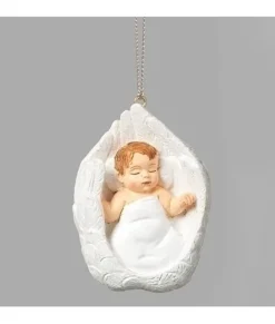 Ornement, bébé bercé dans des ailes blanches