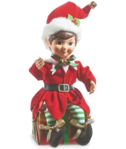 Pièce de table, elfe en rouge, assis sur le cadeau de Noël