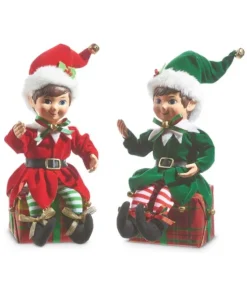 Pièce de table, elfe en rouge, assis sur le cadeau de Noël